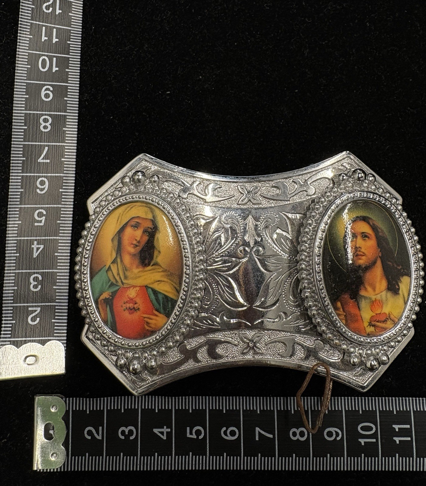 Vintage silver toned belt buckle features oval portraits of Jesus and Mary RARE