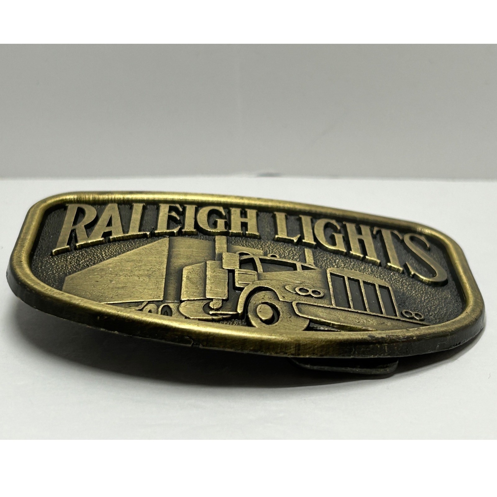 Vintage Raleigh Lights Semi Truck Belt Buckle Metal Antique Western Trucker