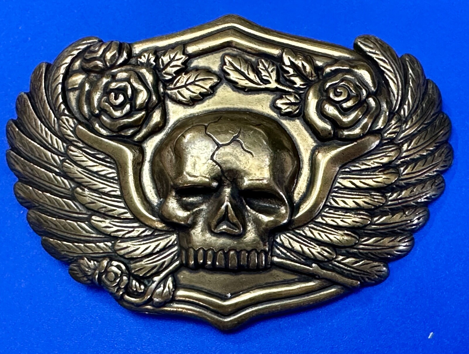 Dimensional Skull Head With Wings And Flowers – Raised Metal Belt Buckle
