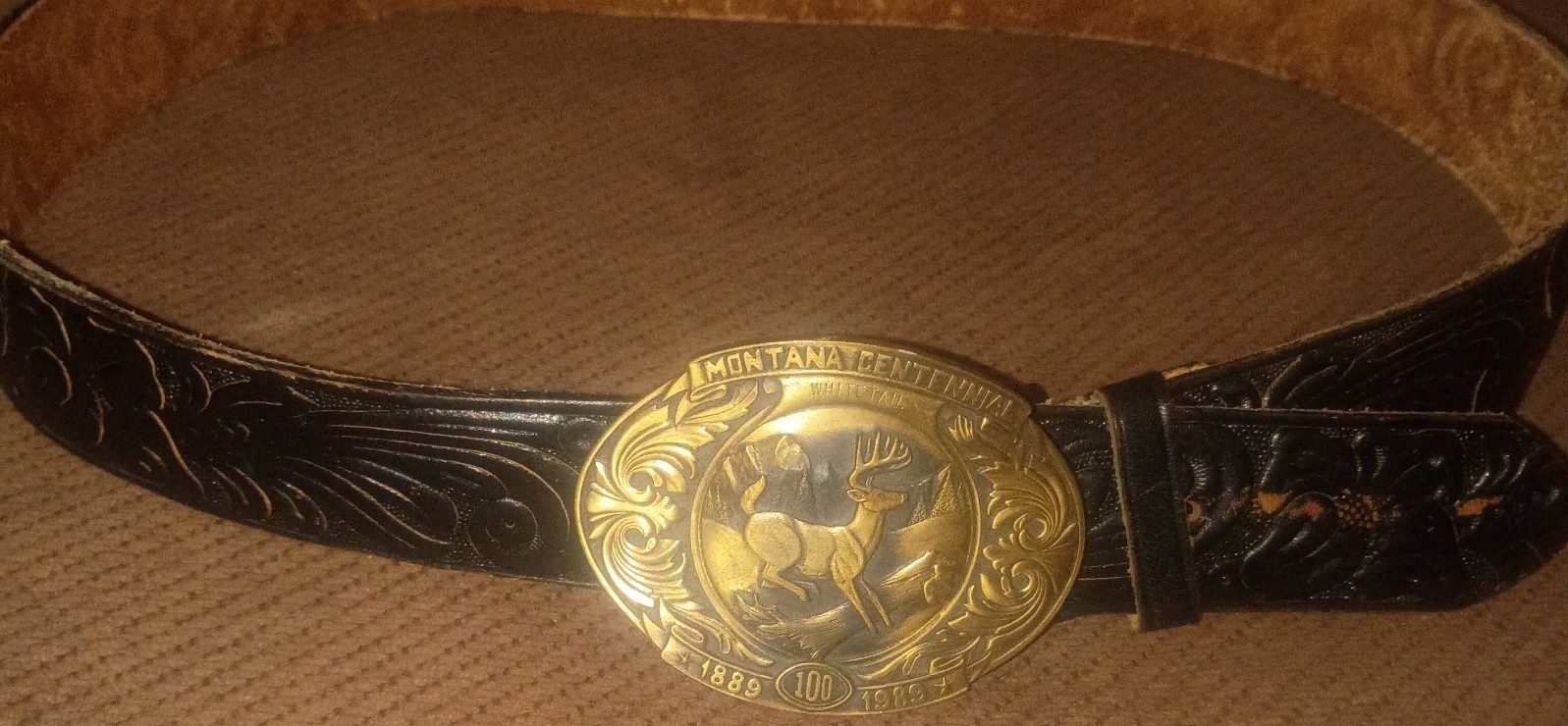 Vintage Montana Centennial Belt Buckle on antique black leather belt with design
