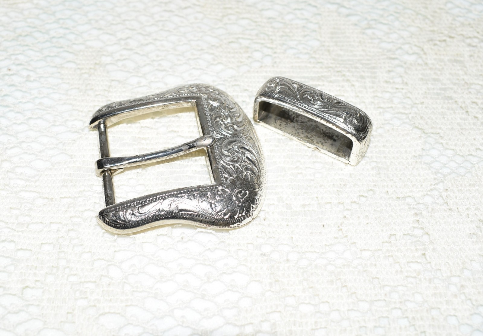 Pre-owned Belt Buckle, Silver in color. 2.5&Prime; x 2.5&Prime; Dated R 1999