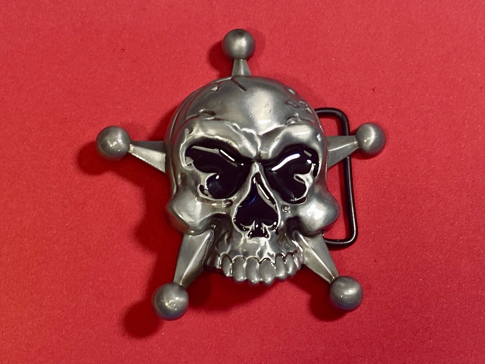 Skull with evil grin! in five point badge style star w/ Black Eyes belt buckle