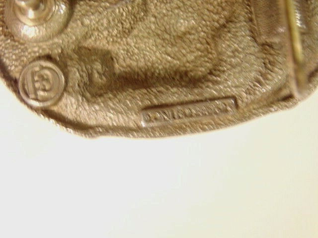 heavy older enameled buckle showing a leaping fish; CJ Inc., 1986, Made in USA