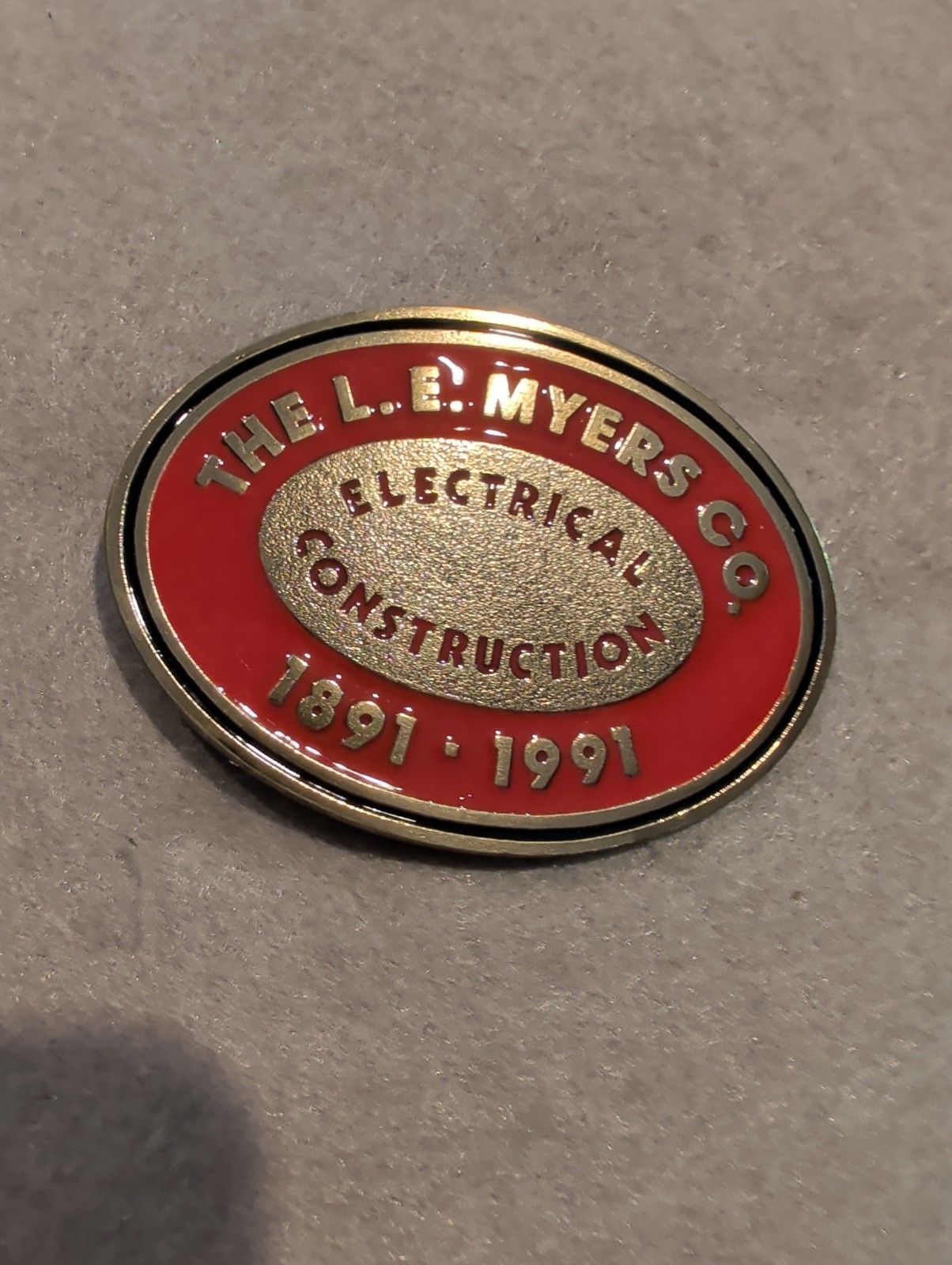 L.E. Myers Co Electrical Construction 1891-1991 Oval Red/Gold Metal Belt Buckle