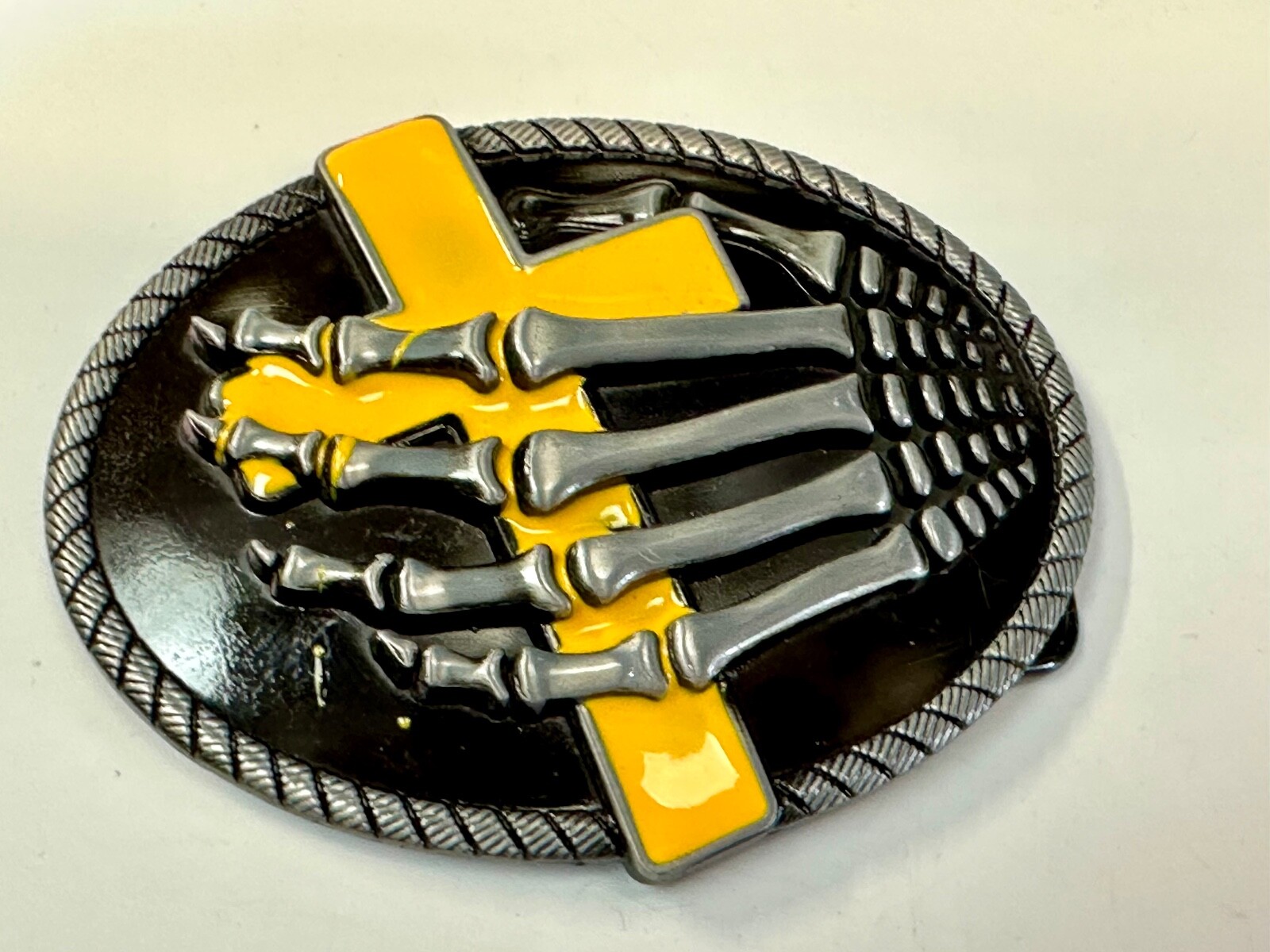 Skeleton Hand Holding Yellow Cross Vintage Dimensional Raised Belt Buckle