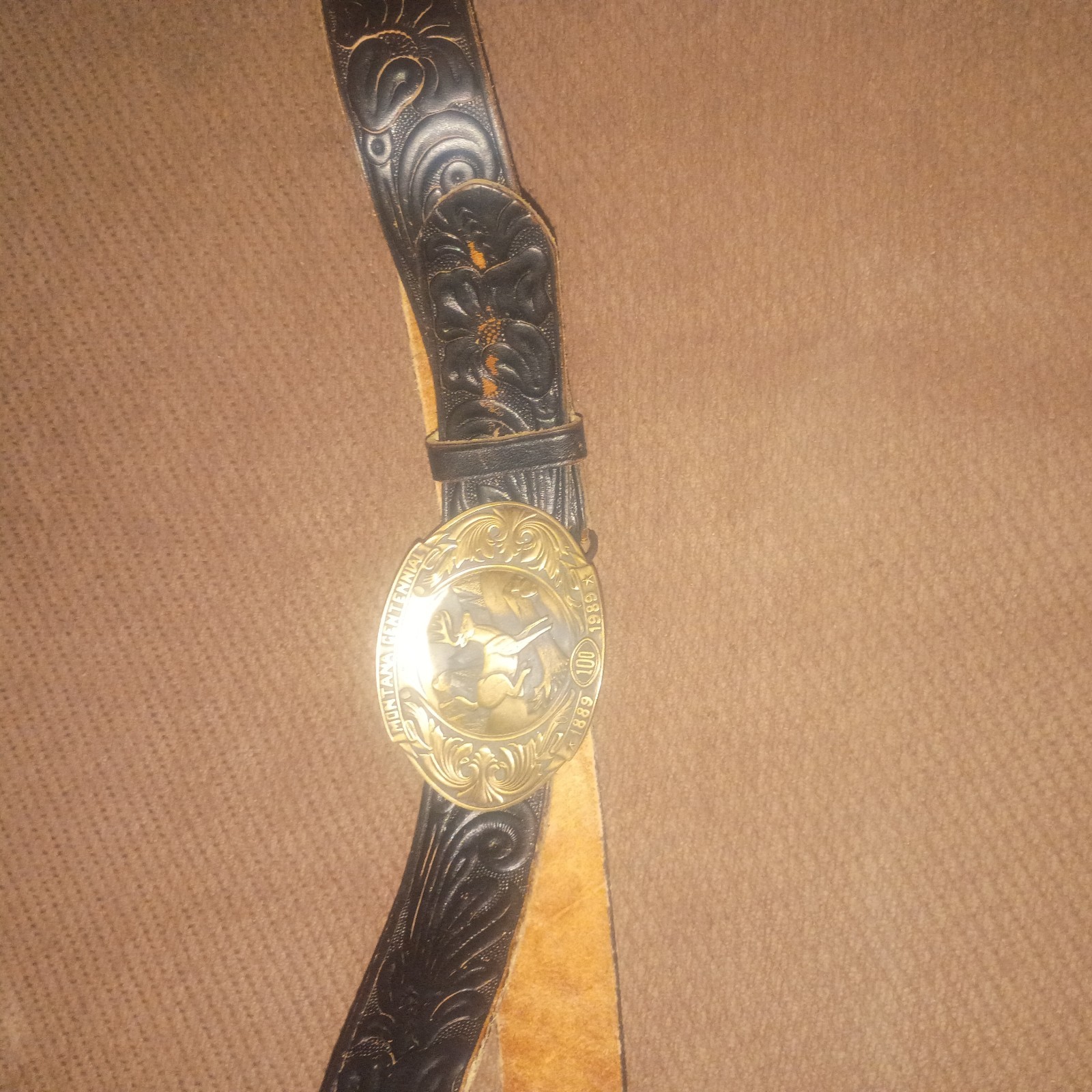 Vintage Montana Centennial Belt Buckle on antique black leather belt with design