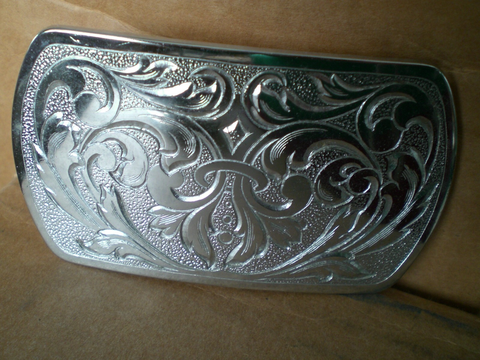 2 silver tone shiny belt buckles