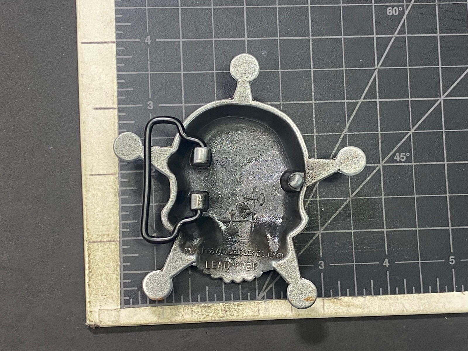 Skull with evil grin! in five point badge style star w/ Black Eyes belt buckle