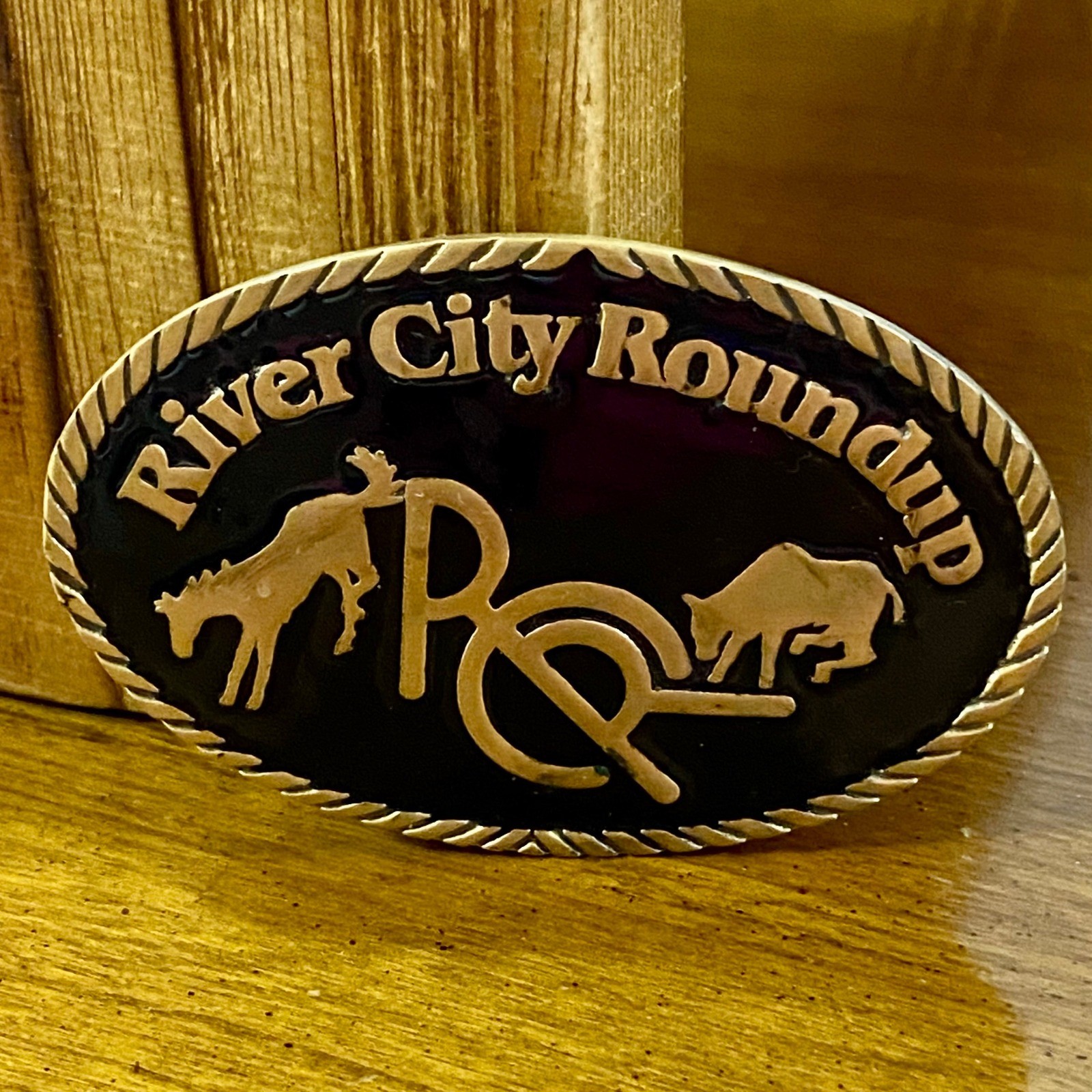 Vintage 1982 River City Roundup Belt Buckle Tapco Gold Tone Black Enamel Rodeo