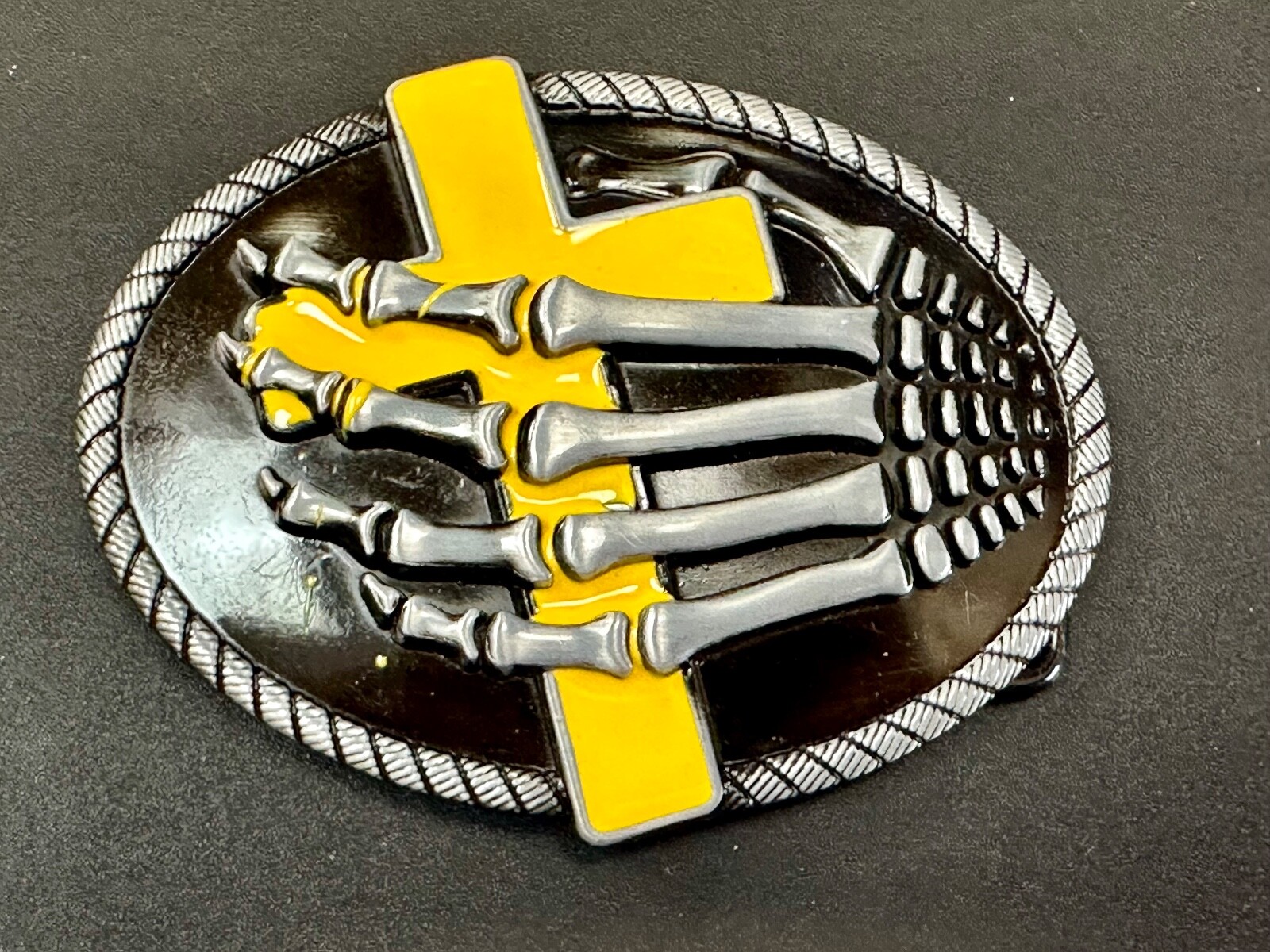Skeleton Hand Holding Yellow Cross Vintage Dimensional Raised Belt Buckle