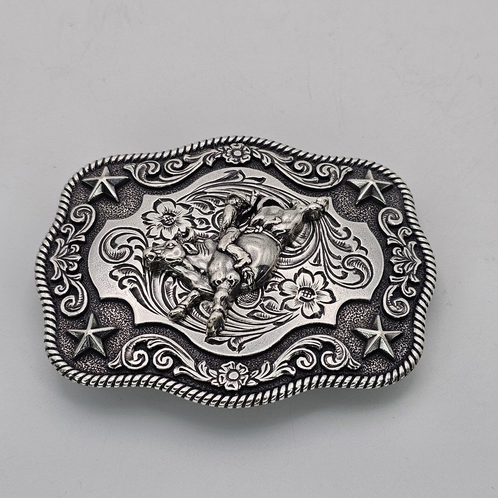 Nocona Western Belt Buckle Bull Rider Rope Edge Rectangular Silver Tone Stars