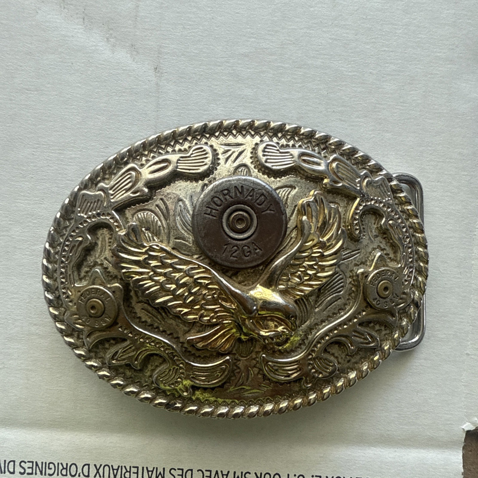 VINTAGE AMERICAN EAGLE BELT BUCKLE WITH HORNADY 12 AND 2 S&W 40 SHELLS