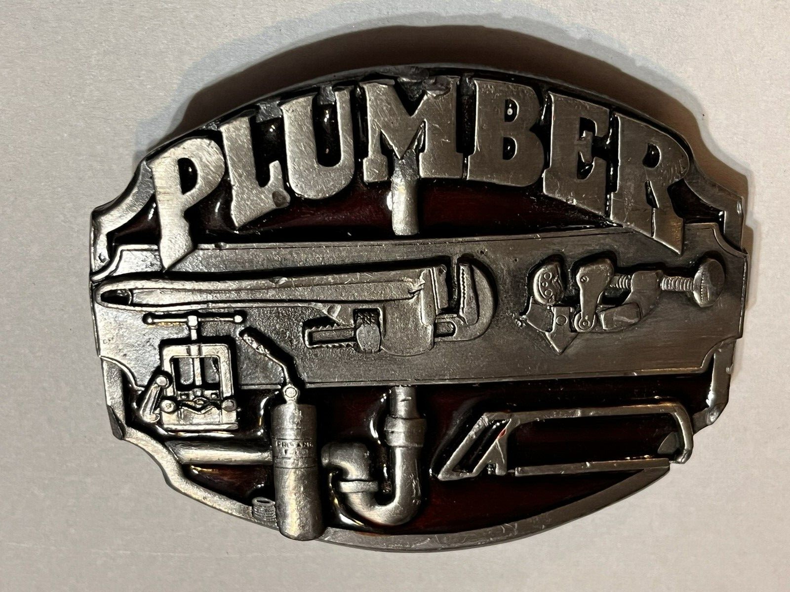 NICE PLUMBER BELT BUCKLE SOLID PEWTER WITH RED 1987 MADE IN USA SISKIYOU CO