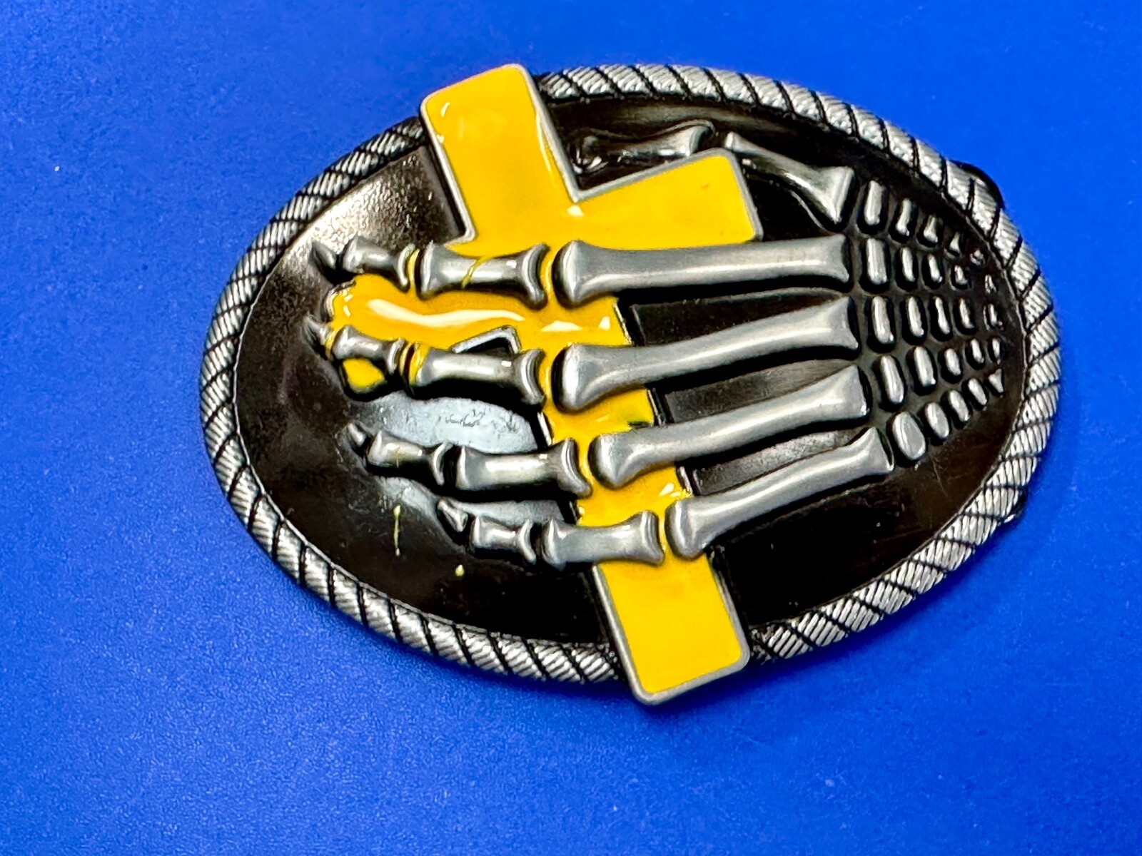 Skeleton Hand Holding Yellow Cross Vintage Dimensional Raised Belt Buckle