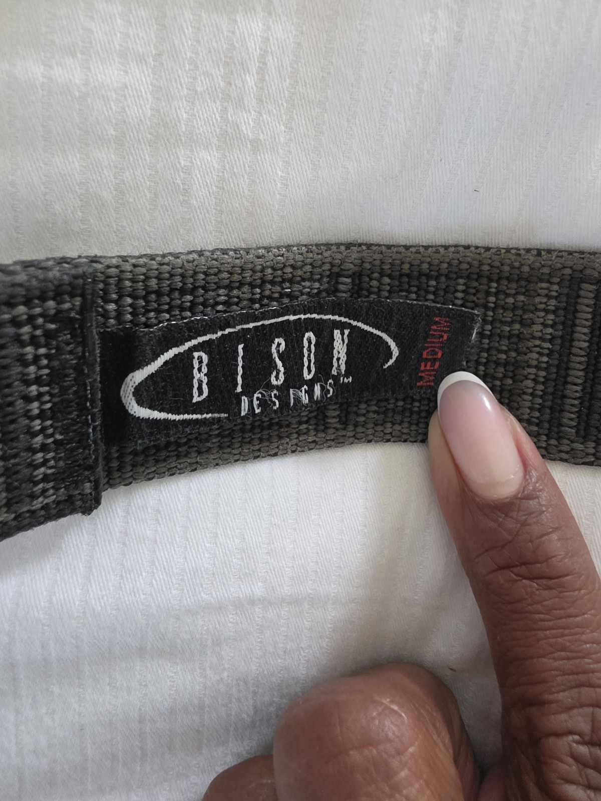 Bison Designs Tap Cap 38 mm belt featuring a gunmetal-colored bottle opener