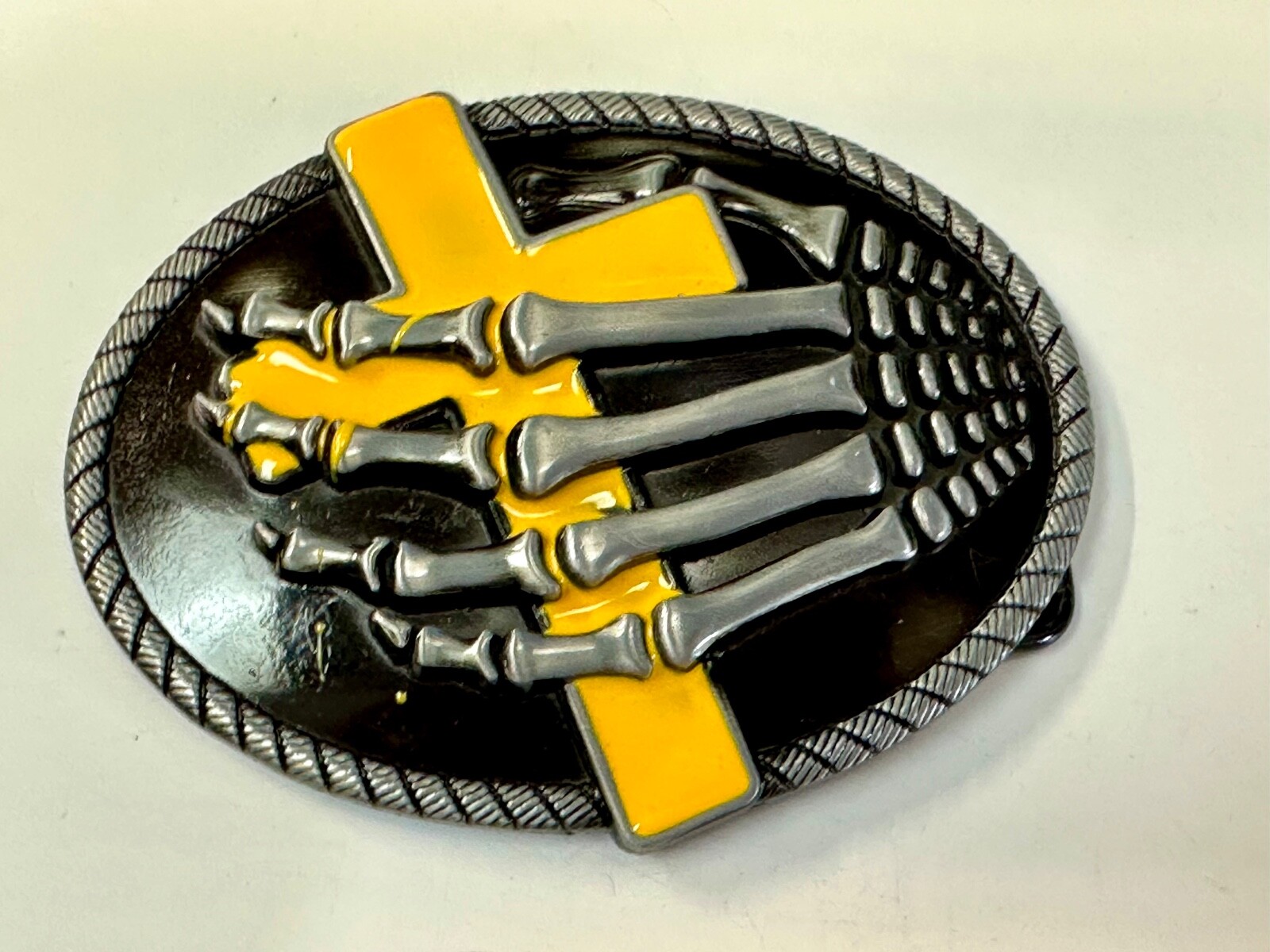 Skeleton Hand Holding Yellow Cross Vintage Dimensional Raised Belt Buckle