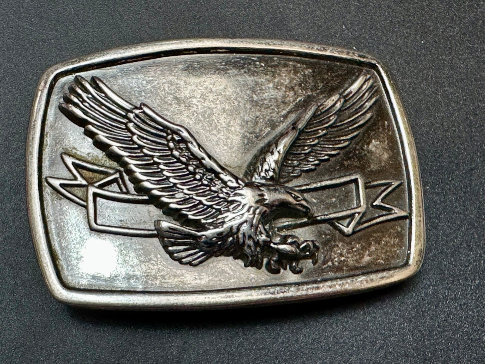 American Eagle With Wings Wide Flying High In Front Of Ribbon Belt Buckle