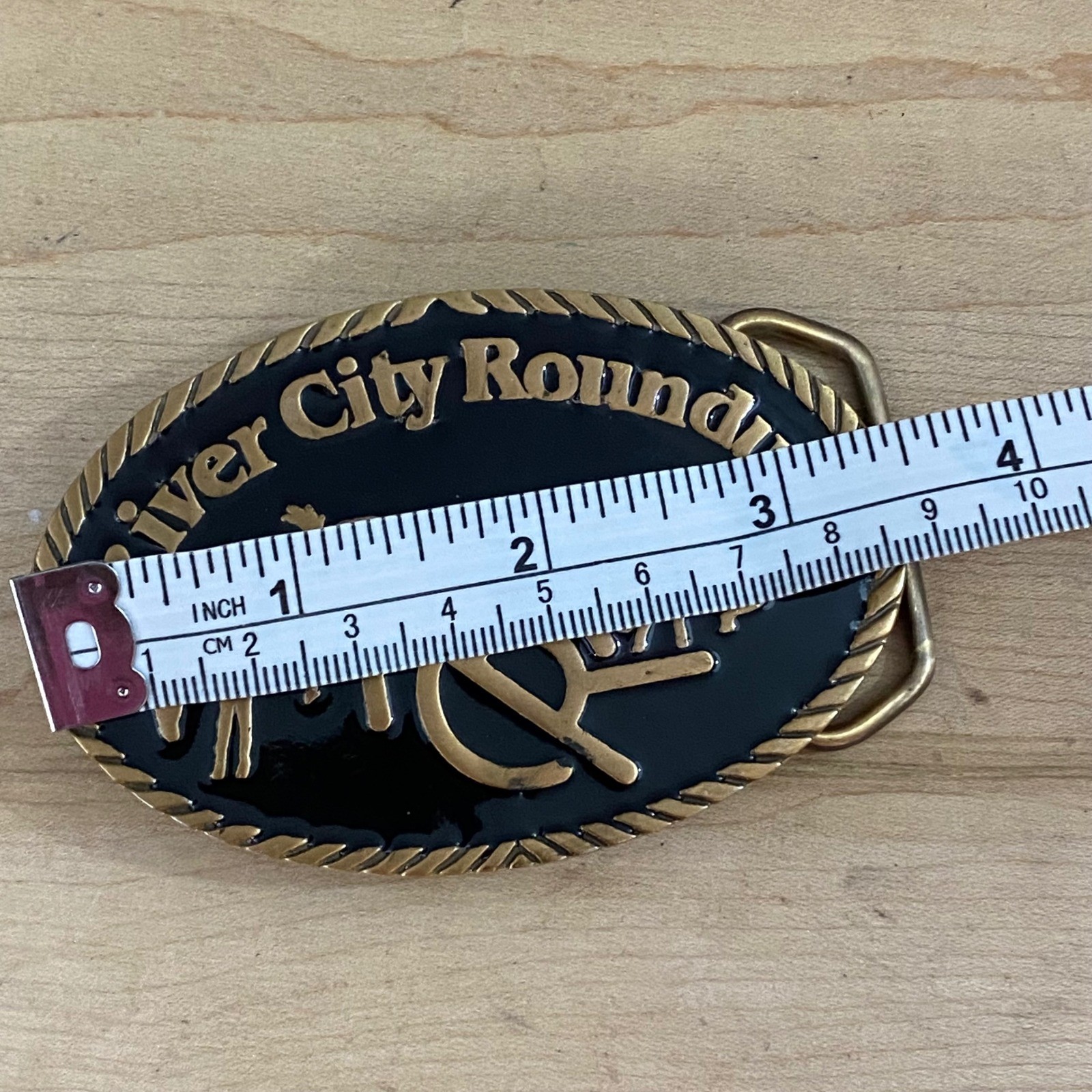 Vintage 1982 River City Roundup Belt Buckle Tapco Gold Tone Black Enamel Rodeo