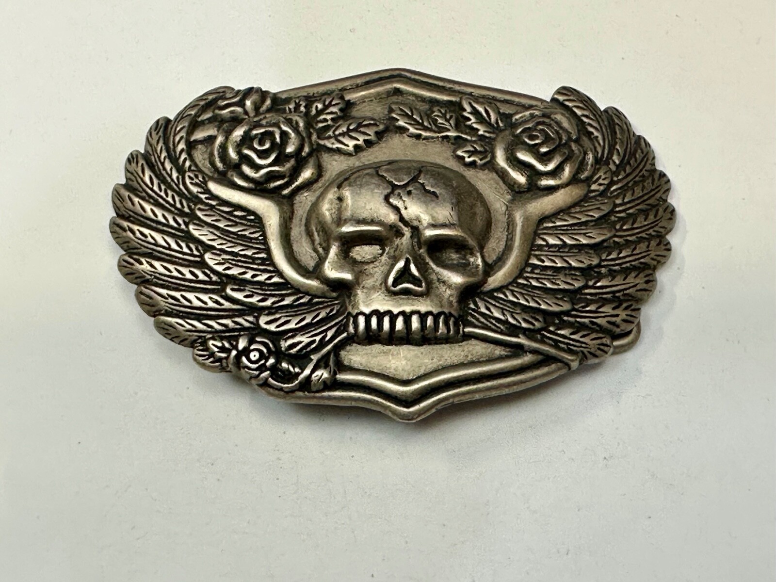 Dimensional Skull Head With Wings And Flowers – Raised Belt Buckle