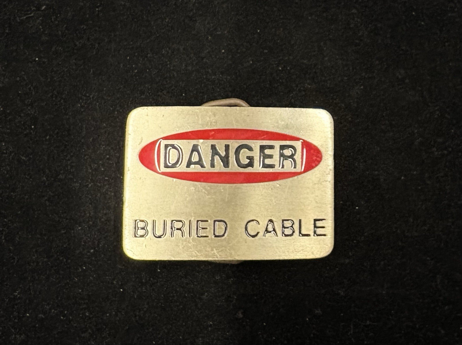 Vintage silver “Danger Buried Cabel” novelty belt buckle red and white RARE