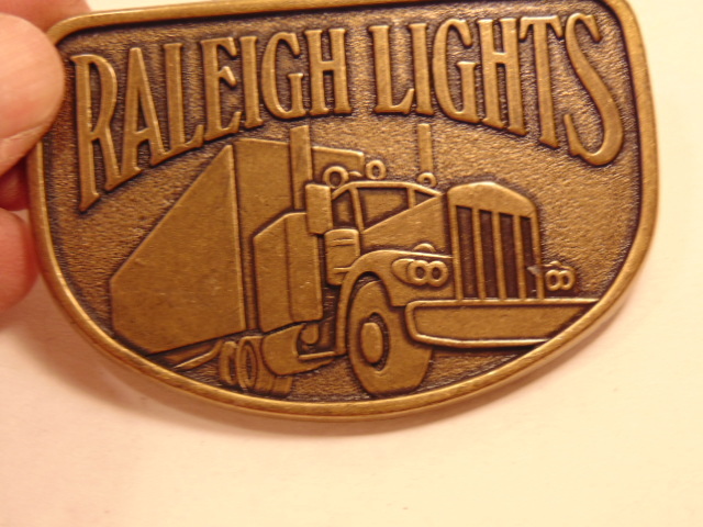 Modern brass colored advertising / trucker belt buckle: Raleigh Lights