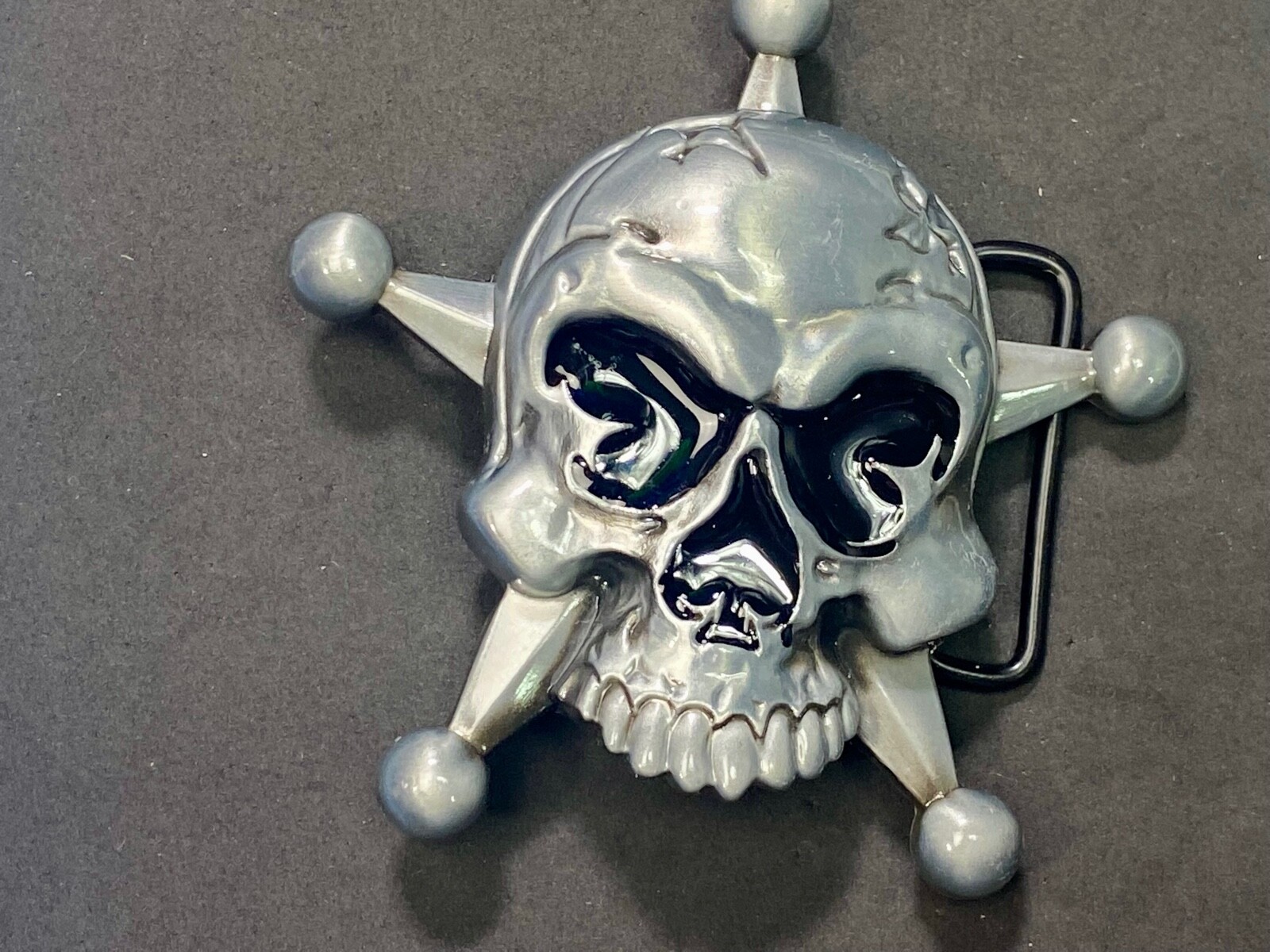 Skull with evil grin! in five point badge style star w/ Black Eyes belt buckle