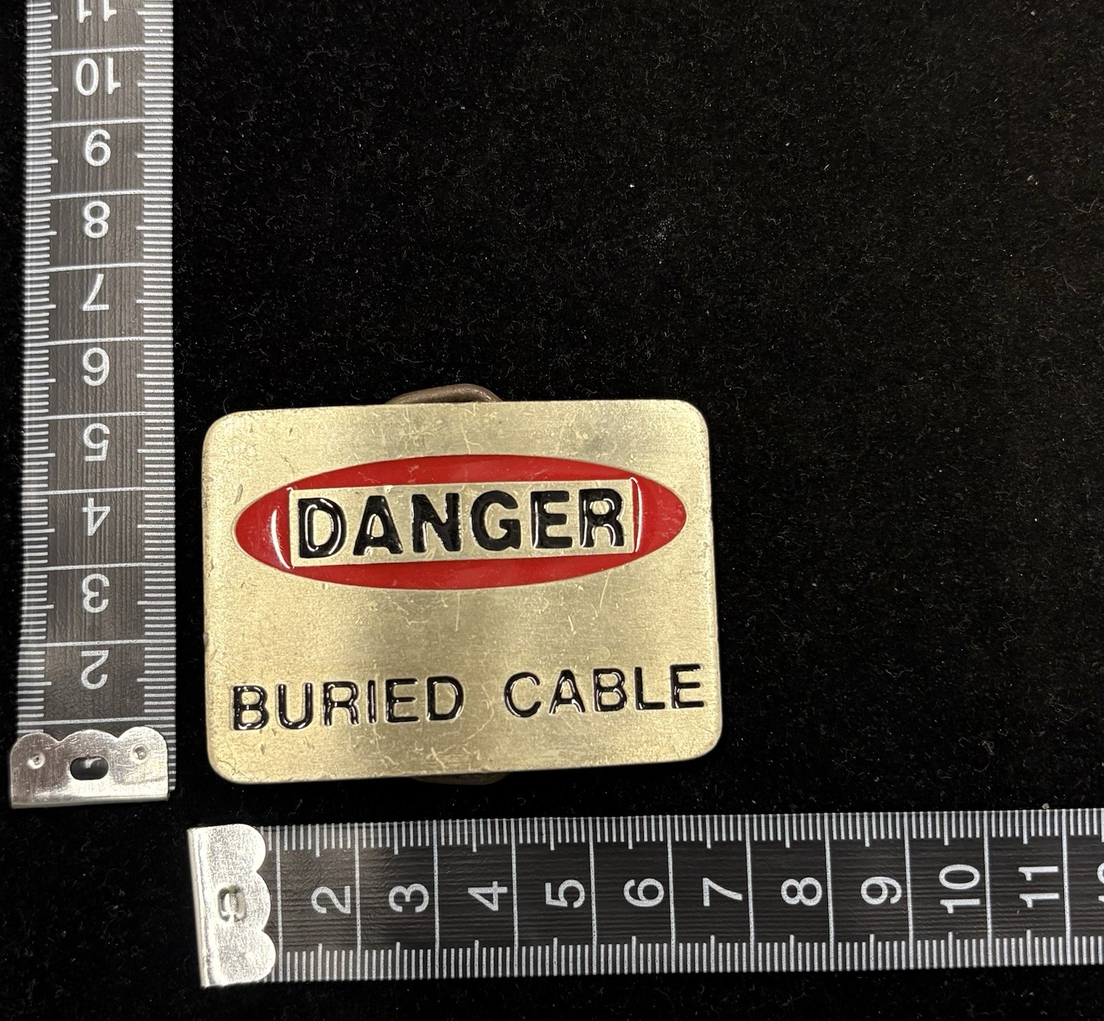 Vintage silver “Danger Buried Cabel” novelty belt buckle red and white RARE