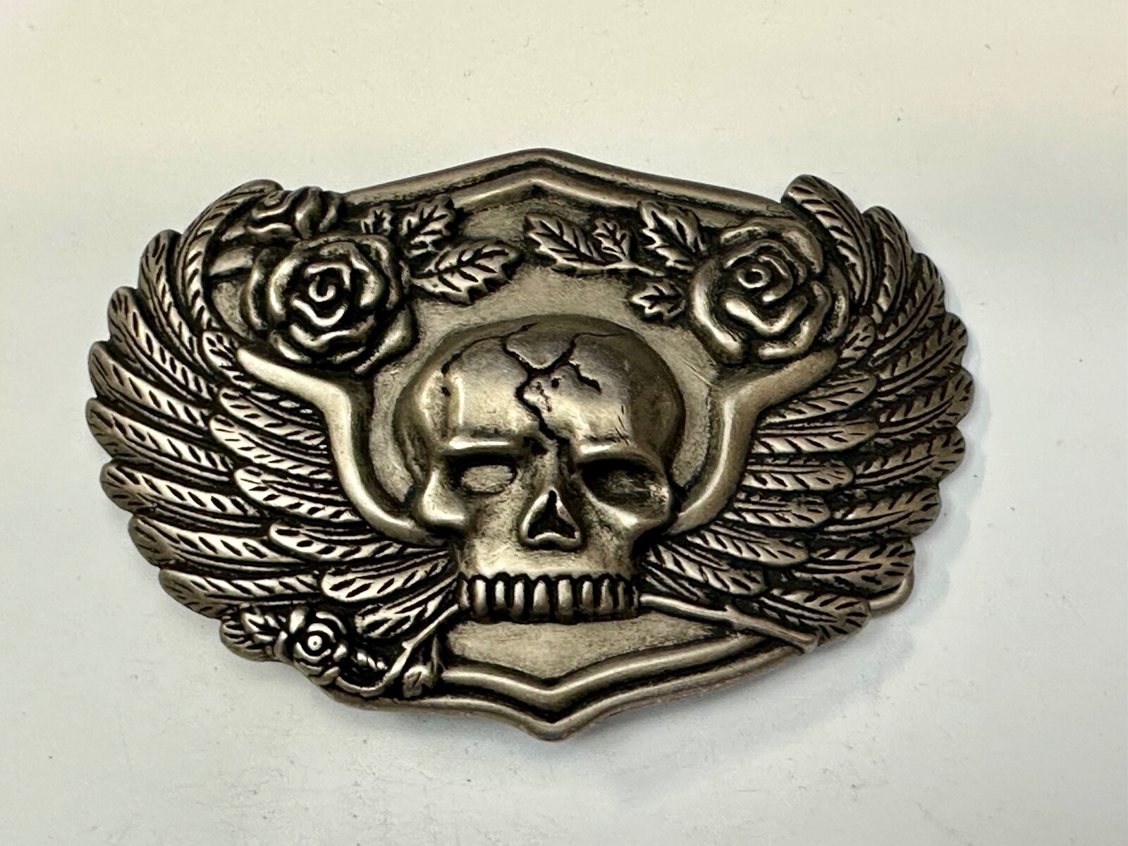 Dimensional Skull Head With Wings And Flowers – Raised Belt Buckle
