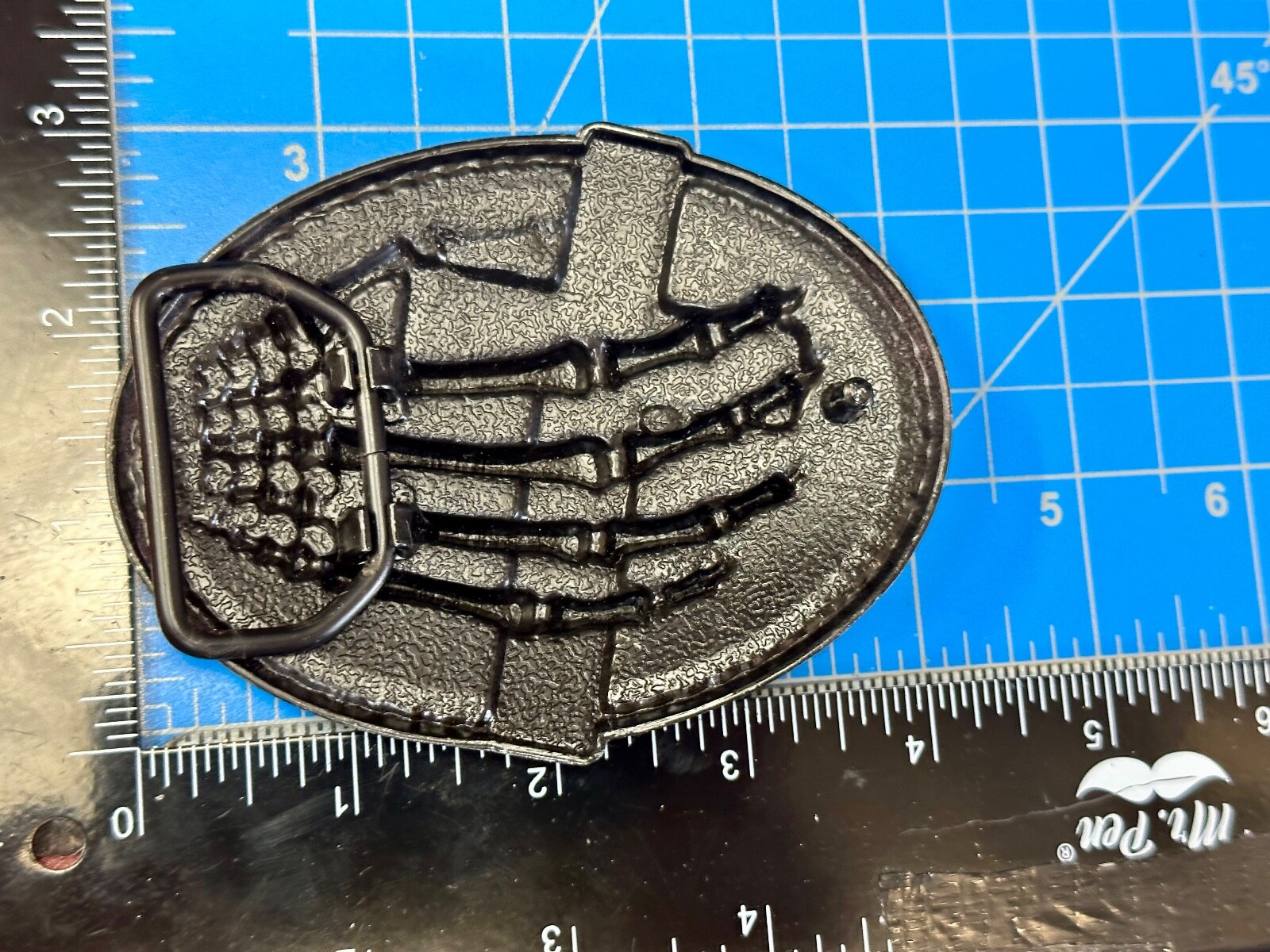 Skeleton Hand Holding Yellow Cross Vintage Dimensional Raised Belt Buckle