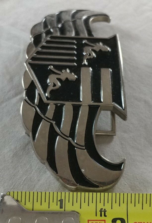 WINGS SHIELD MUD FLAP GIRL CREST BOTTLE OPENER BELT BUCKLE PRONG NEEDS REPAIR