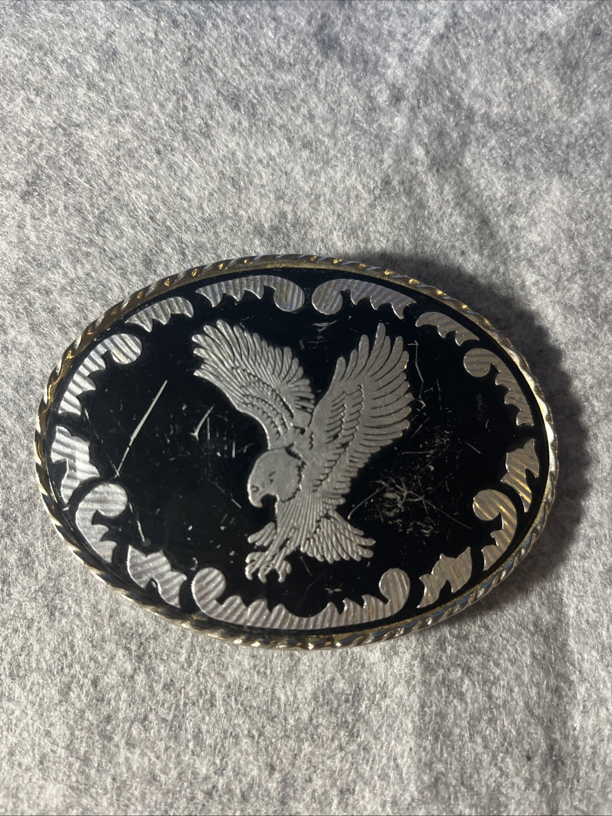 Silver-toned Belt Buckle with Black Enamel and Flying Eagle. Made in USA.