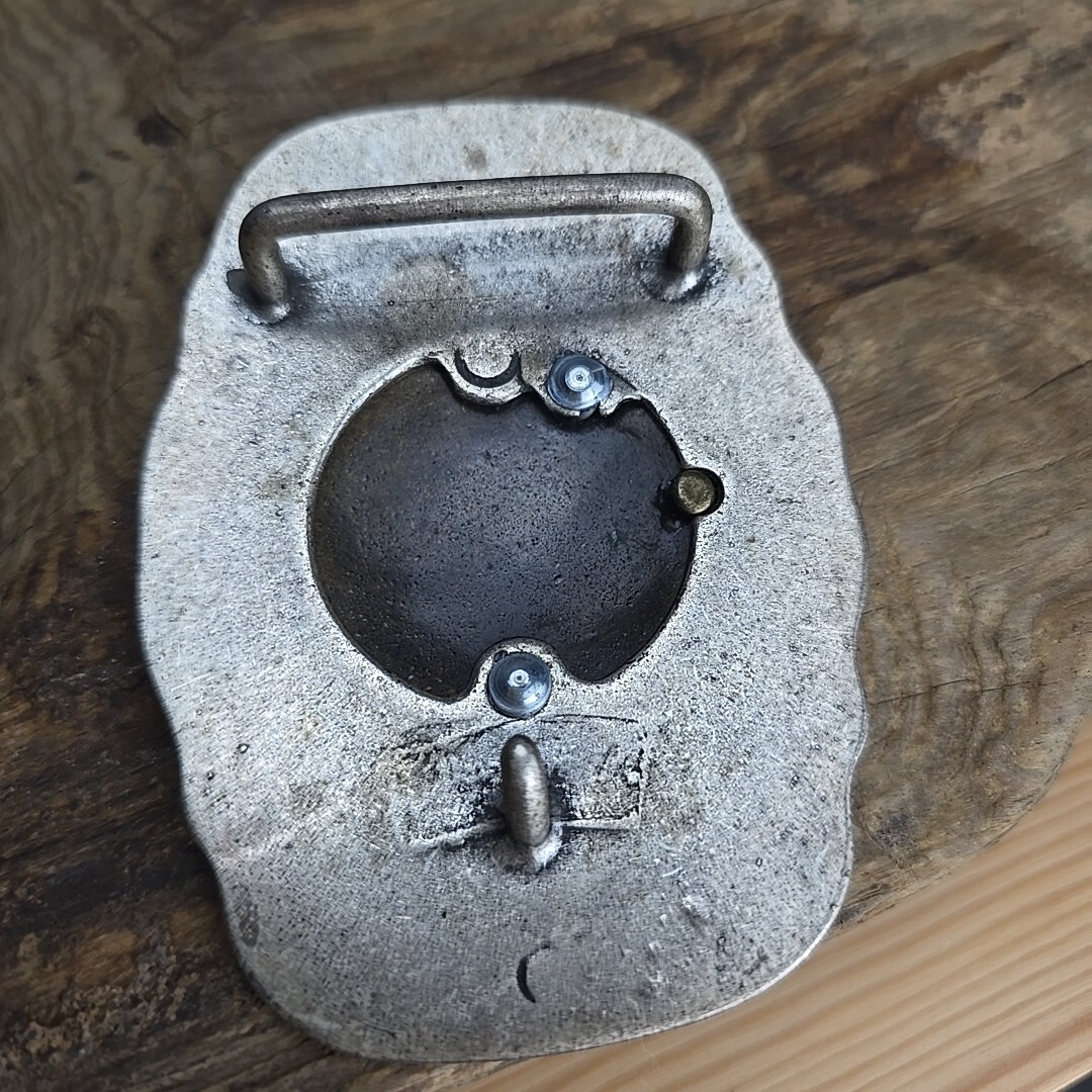 Unique vintage brass and steel belt buckle.