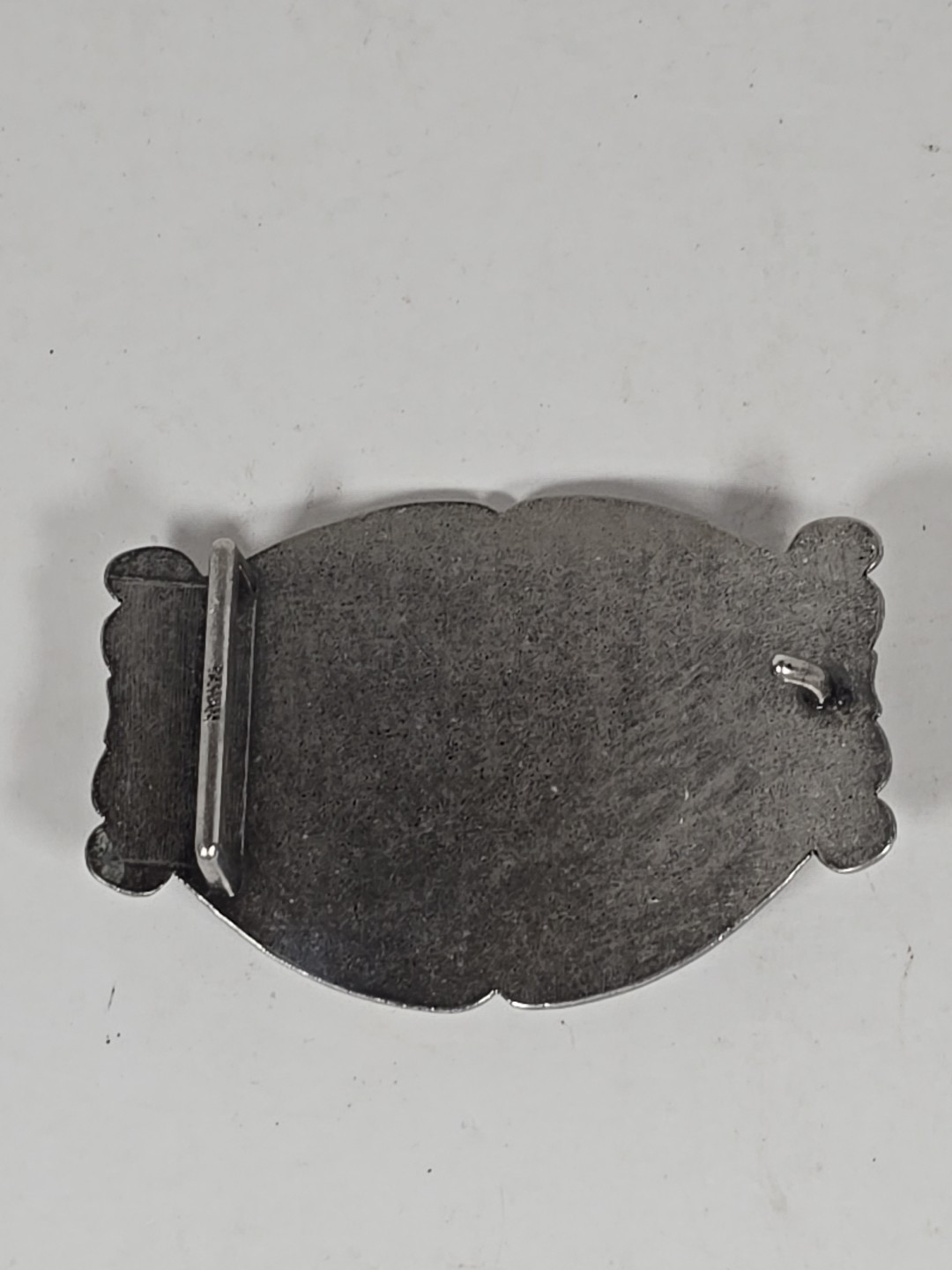 Silver Tone Belt Buckle With Eagle In Flight Against A Mountain Backdrop