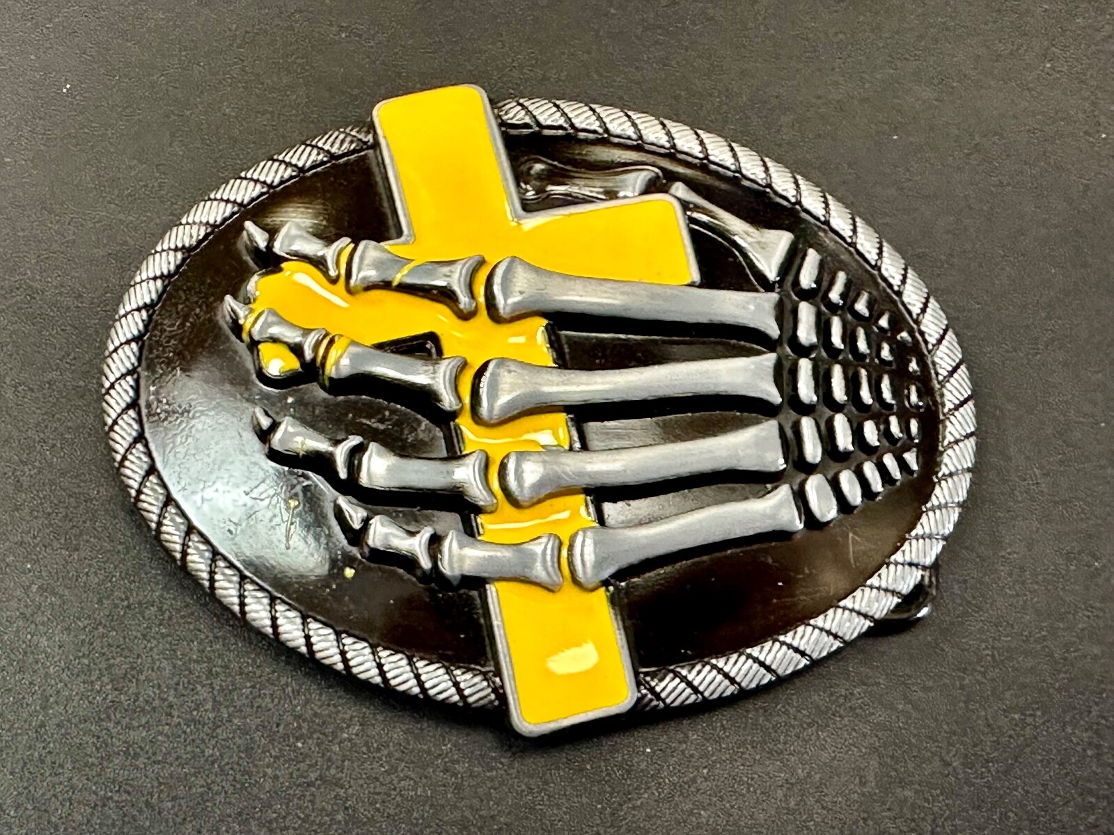 Skeleton Hand Holding Yellow Cross Vintage Dimensional Raised Belt Buckle