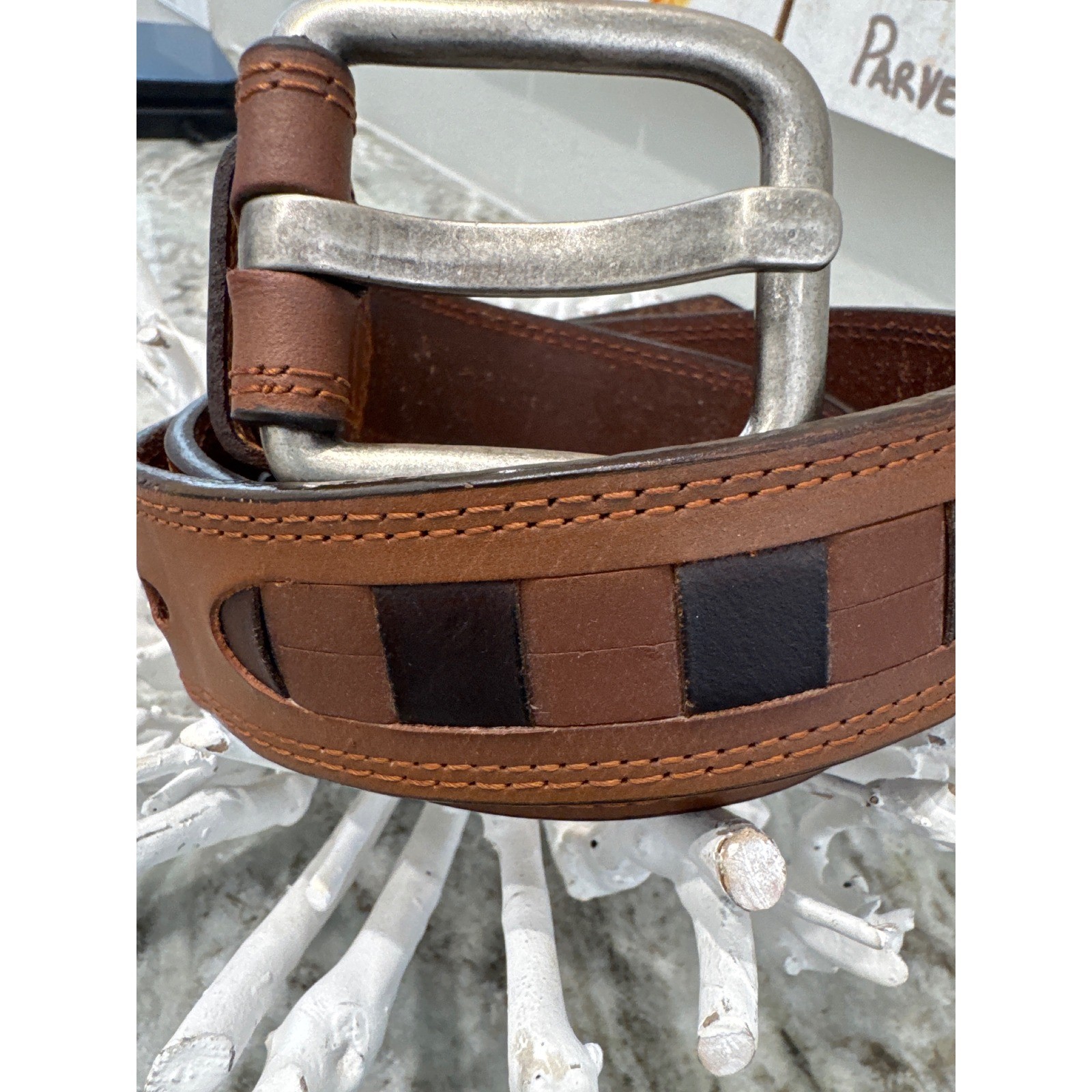 Men&rsquo;s brown leather belt featuring a prominent woven-inlay pattern size 44