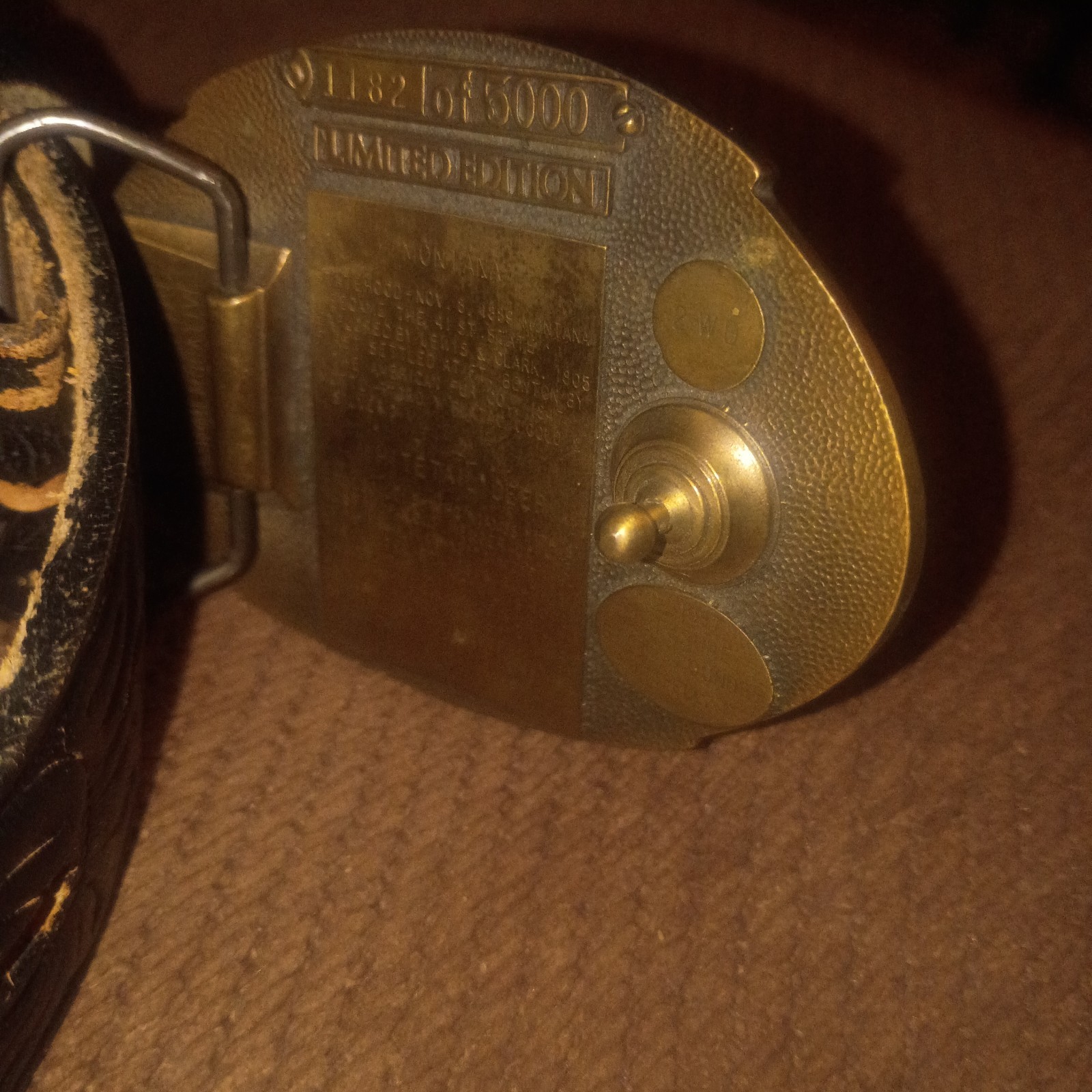 Vintage Montana Centennial Belt Buckle on antique black leather belt with design