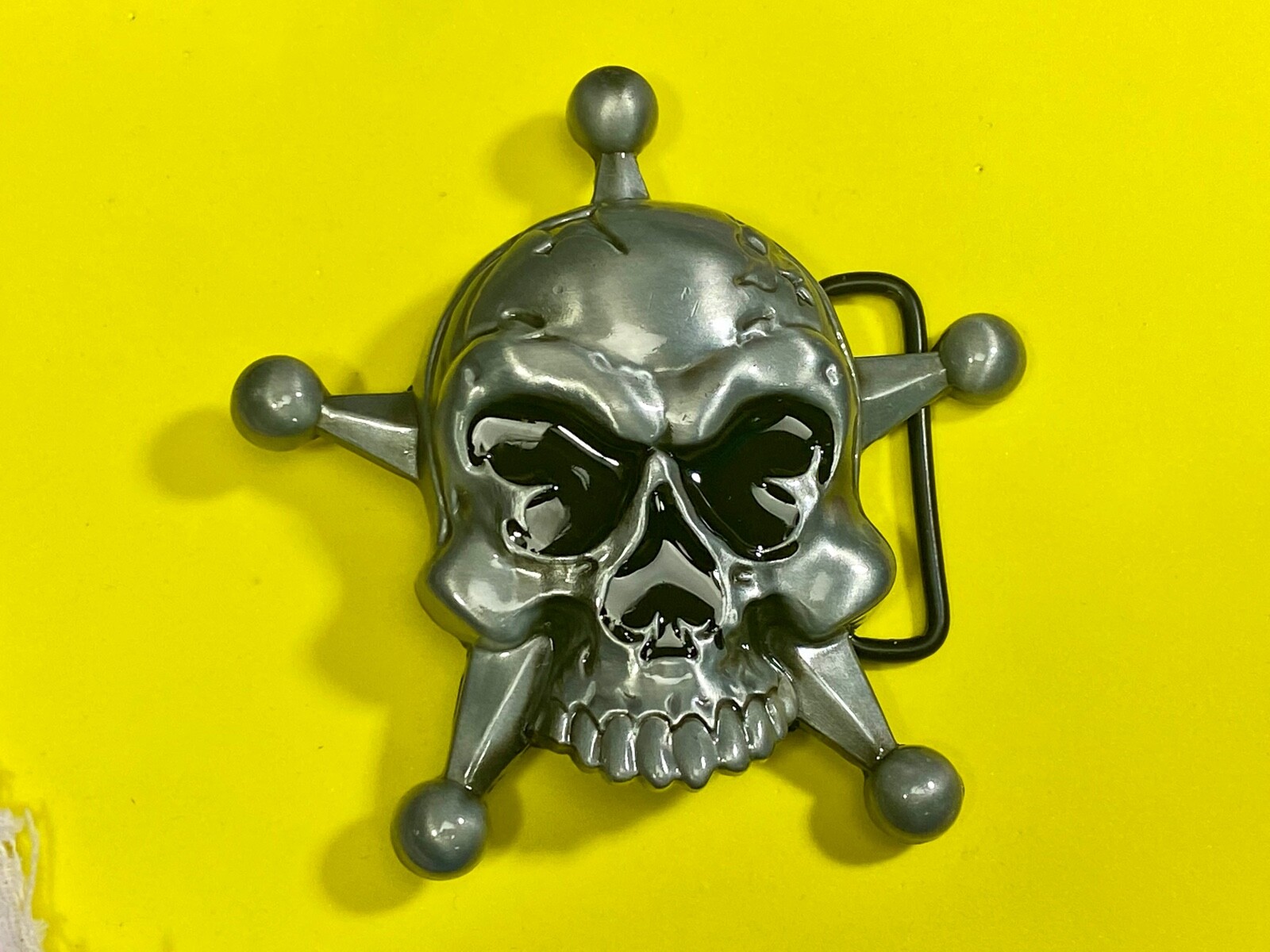 Skull with evil grin! in five point badge style star w/ Black Eyes belt buckle