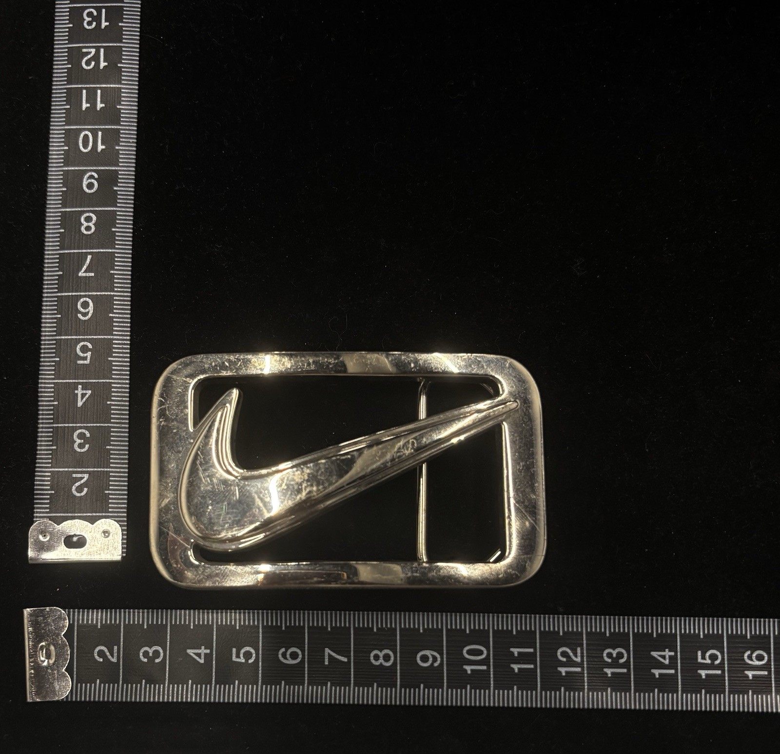 vintage Nike Y2K belt buckle features a polished metal construction RARE