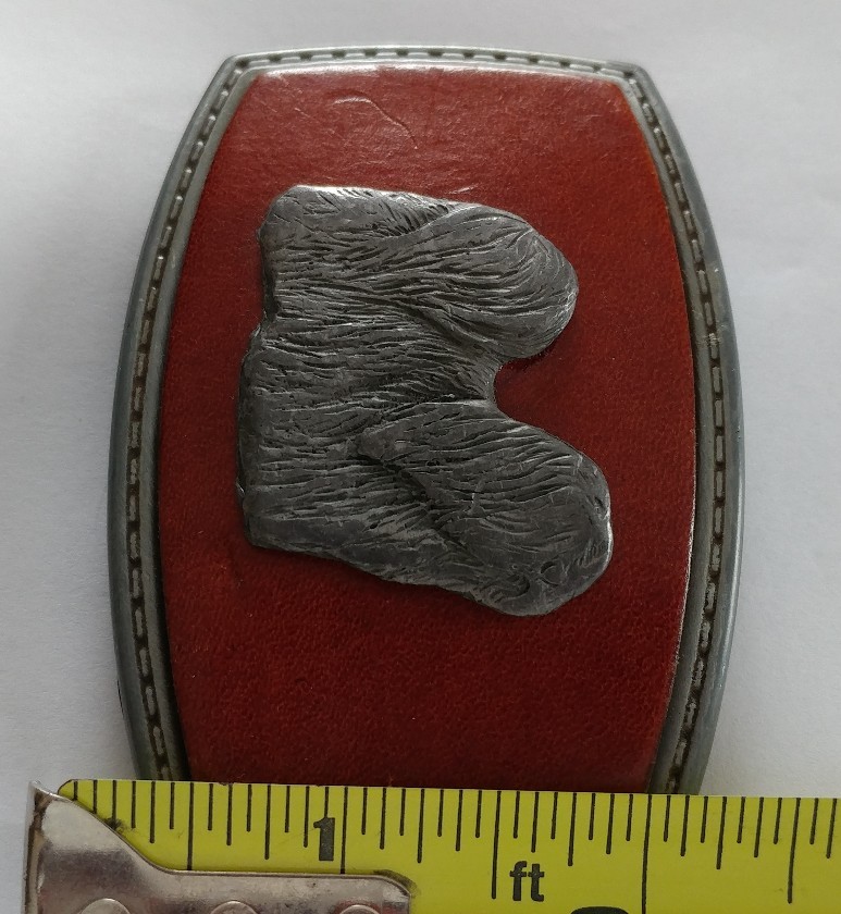 LONG HAIR DOG LHASA APSO ON A RED LEATHER PIECE SET ON A BELT BUCKLE