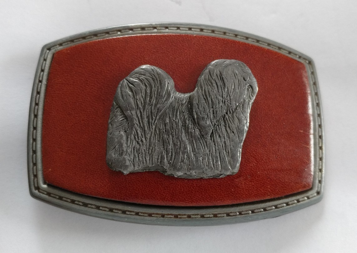 LONG HAIR DOG LHASA APSO ON A RED LEATHER PIECE SET ON A BELT BUCKLE