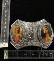 Vintage silver toned belt buckle features oval portraits of Jesus and Mary RARE