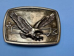 American Eagle With Wings Wide Flying High In Front Of Ribbon Belt Buckle