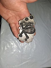 unbranded gothic belt buckle features a 3D pile of skulls and crossed bones…