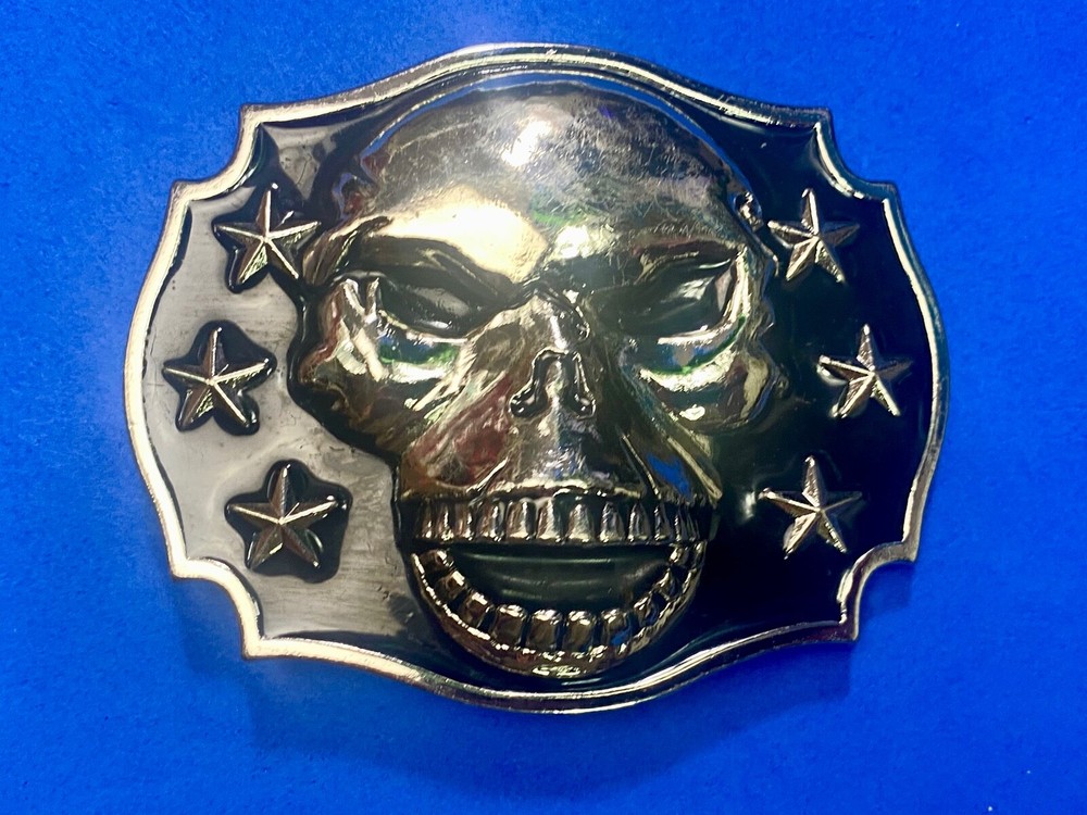 Raised Skull With Teeth Grin Black And Silver Color Belt Buckle Star Surround