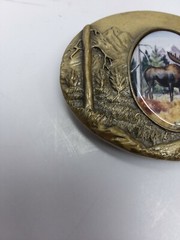 Artistic impression MOOSE belt buckle designed by Julie Zsupnik, 2004