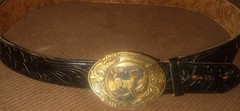 Vintage Montana Centennial Belt Buckle on antique black leather belt with design