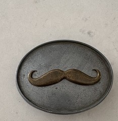 BevBuckle mustache belt buckle designed to hold drinks hands-
