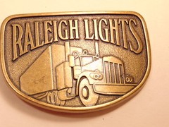 Modern brass colored advertising / trucker belt buckle: Raleigh Lights