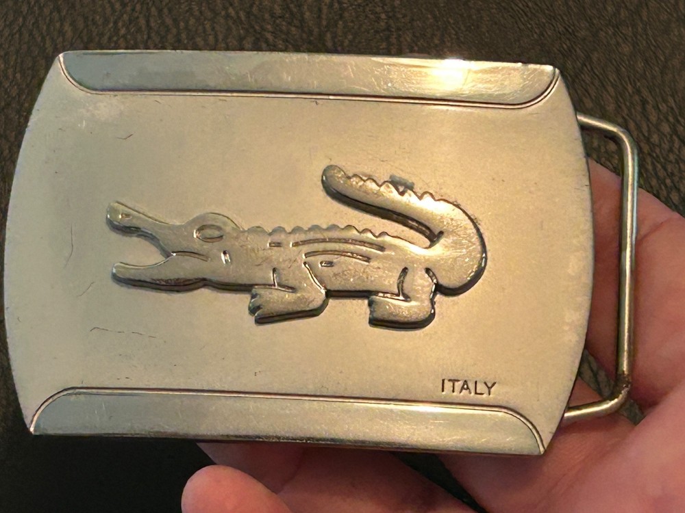 Silver-toned metal belt buckle, embossed crocodile logo and « ITALY »