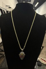 gold rope chain necklace features a gothic skull pendant with red stone eyes